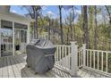 Enjoy outdoor cooking on this deck with a grill overlooking a serene wooded area at 1821 Mead Ln, Johns Island, SC 29455