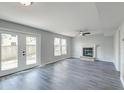 Inviting living area with a cozy fireplace, sliding glass doors, and sleek wood-look flooring at 2076 Wild Flower Ln, Charleston, SC 29414