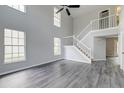 Bright living room boasting soaring ceilings, large windows, and elegant gray wood floors at 2076 Wild Flower Ln, Charleston, SC 29414