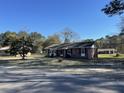 Quaint brick home showcases its classic architecture and peaceful surroundings against a clear blue sky at 260 Carolina Cir, Walterboro, SC 29488