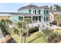 Stunning exterior of a teal home showcasing lush landscaping and inviting staircase at 2777 Oak Manor Dr, Mount Pleasant, SC 29466