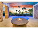 Inviting pool area featuring a modern fire pit and elegant brick accents at 2777 Oak Manor Dr, Mount Pleasant, SC 29466
