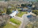 An aerial view showing a home with a metal roof, and a long driveway on a well maintained lot at 305 Meadowlark Ln, Moncks Corner, SC 29461