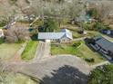 An aerial view of a home with fenced backyard, long driveway, and well maintained front lawn at 305 Meadowlark Ln, Moncks Corner, SC 29461