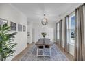 Bright dining room with a chandelier, large windows, and an elegant rug under the table at 3199 Great Egret Dr, Johns Island, SC 29455