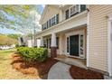 Inviting front porch with brick supports and a dark green front door with sidelights at 3529 Galaxy Rd, Ladson, SC 29456