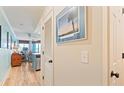 Hallway leading into an open-concept living area, showcasing coastal decor and a light, airy atmosphere at 3701 Docksite Rd # 108, Edisto Beach, SC 29438