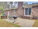 Brick house featuring an outdoor area perfect for grilling and dining with a grill and table set at 407 Boone Hill Rd, Summerville, SC 29483