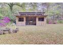 Backyard shed with a rustic design and a partially covered seating area, ideal for outdoor activities at 407 Boone Hill Rd, Summerville, SC 29483