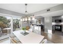 Open floorplan dining area with views of the living room and outdoor patio at 4364 Sea Forest Dr, Kiawah Island, SC 29455