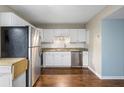 Modern kitchen features stainless steel appliances, white cabinetry, and granite countertops at 507 Stinson Dr # 3A, Charleston, SC 29407
