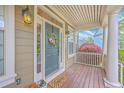 Inviting front porch adorned with a wreath, welcome mat, and lantern sconces showcasing southern charm at 5411 Nesting Pl, North Charleston, SC 29420
