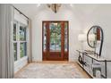 Inviting foyer with hardwood floors, stylish console table, contemporary lighting, and decorative mirror at 6 Beverly Rd, Charleston, SC 29407