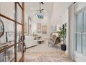 Bright living room with a vaulted ceiling, large windows, hardwood floors, and stylish decor at 6 Beverly Rd, Charleston, SC 29407