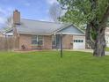 Beautiful single Gathering home with a well-manicured lawn, brick facade, and an attached one-car garage at 8530 Bentwood Dr, North Charleston, SC 29406