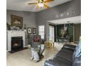 Open-concept living room with fireplace, vaulted ceilings, and seamless flow into dining area, enhanced by natural light at 8530 Bentwood Dr, North Charleston, SC 29406