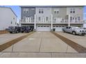 Rear view of townhomes shows garages, back decks, and parking areas for residents at 861 Recess Point Dr, Moncks Corner, SC 29461