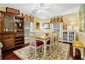 Inviting dining room features a decorative rug, cabinet, and a large dining table with seating for six at 864 Club Cottage Rd, Edisto Beach, SC 29438
