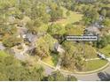 Aerial view of home with lush trees, golf course views, and neighborhood streets at 8795 E Fairway Woods Cir, North Charleston, SC 29420