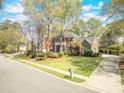 Attractive two-story brick home with a well-maintained lawn and mature trees in a peaceful neighborhood at 8795 E Fairway Woods Cir, North Charleston, SC 29420