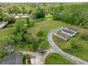 Wide angle shot of three houses, with creek, road and powerlines on the property at 0 James Bell Dr, North Charleston, SC 29406