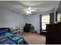 Cozy bedroom with a ceiling fan and a view from the window at 104 Queen Mary Ct, Summerville, SC 29485