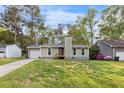 Charming ranch-style home boasts a quaint front porch, a cozy chimney, and a manicured lawn at 109 Sawmill Dr, Summerville, SC 29483
