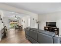 Open-concept living room with hardwood floors leading to the dining area, ideal for gatherings at 109 Sawmill Dr, Summerville, SC 29483
