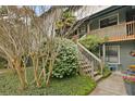 Inviting exterior of a home with beautiful greenery, a wooden staircase, and a cozy balcony at 1120 Hidden Cove Dr # I, Mount Pleasant, SC 29464
