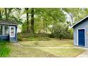 Spacious backyard featuring a lush lawn, garden beds, and mature trees at 1438 Arrow Wind Ter, Charleston, SC 29414