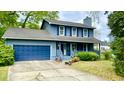 Charming two-story home with a welcoming front porch, garage and beautiful blue siding at 1438 Arrow Wind Ter, Charleston, SC 29414
