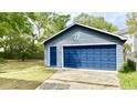 Detached garage with a large blue door and matching side door at 1438 Arrow Wind Ter, Charleston, SC 29414