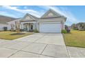 Charming home featuring a two-car garage, well-kept lawn, and a welcoming covered front porch at 145 Billowing Sails St, Summerville, SC 29486