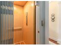 Home elevator featuring wood paneling and gray metal accordion door at 1501 Sea Palms Cres, Mount Pleasant, SC 29464