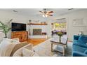 Cozy living room with fireplace, hardwood floors, comfortable seating, and access to an outdoor porch at 1515 Wakendaw Rd, Mount Pleasant, SC 29464