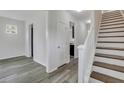 Bright hallway with wood floors and a staircase leading to the upper level at 154 Old Jackson Rd, Goose Creek, SC 29445