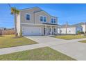 Attractive two-story home featuring a covered front porch and attached two-car garage at 159 Lucky Day Dr, Summerville, SC 29486