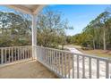 View from the spacious balcony of the surrounding trees and driveway below at 1615 Macoma Rd, Mount Pleasant, SC 29466