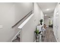Hallway with a staircase, modern decor, and wood-look flooring leading to the living area at 178 Buchanan Cir, Goose Creek, SC 29445