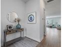 Bright entryway showcasing wood floors, a console table with decor, and an open view into the living area at 183 Country Gate Lane Ln, Summerville, SC 29485