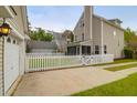 View of the fenced backyard, featuring a white picket fence and a detached garage at 1833 Hubbell Dr, Mount Pleasant, SC 29466