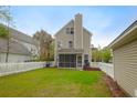 Picture of the backyard showing the screen porch with a white picket fence and a detached garage at 1833 Hubbell Dr, Mount Pleasant, SC 29466