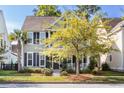 Attractive home with a well-manicured lawn, mature trees and inviting front porch at 1870 Carolina Bay Dr, Charleston, SC 29414