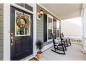 Relaxing front porch with rocking chairs and a welcoming entrance at 1870 Carolina Bay Dr, Charleston, SC 29414