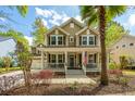 Inviting home featuring a charming front porch, manicured landscaping, and an attached two car garage at 1883 Hall Point Rd, Mount Pleasant, SC 29466