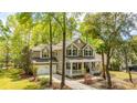 Attractive home with a welcoming front porch, lush landscaping, and an attached two-car garage at 1883 Hall Point Rd, Mount Pleasant, SC 29466