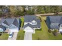 Aerial view of a two-story house with well-maintained landscaping, a driveway, and a spacious backyard at 206 Alpine Rd, Summerville, SC 29485