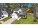 Aerial view of a two-story house with a green lawn, surrounded by trees, and a private driveway at 206 Alpine Rd, Summerville, SC 29485