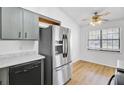 Modern kitchen with stainless steel appliances, marble countertops, and adjacent dining area at 213 Braly Dr, Summerville, SC 29485