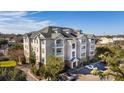Low angle of Condo building, boasting well-maintained grounds and ample parking at 2244 Ashley Crossing Dr # 1232, Charleston, SC 29414